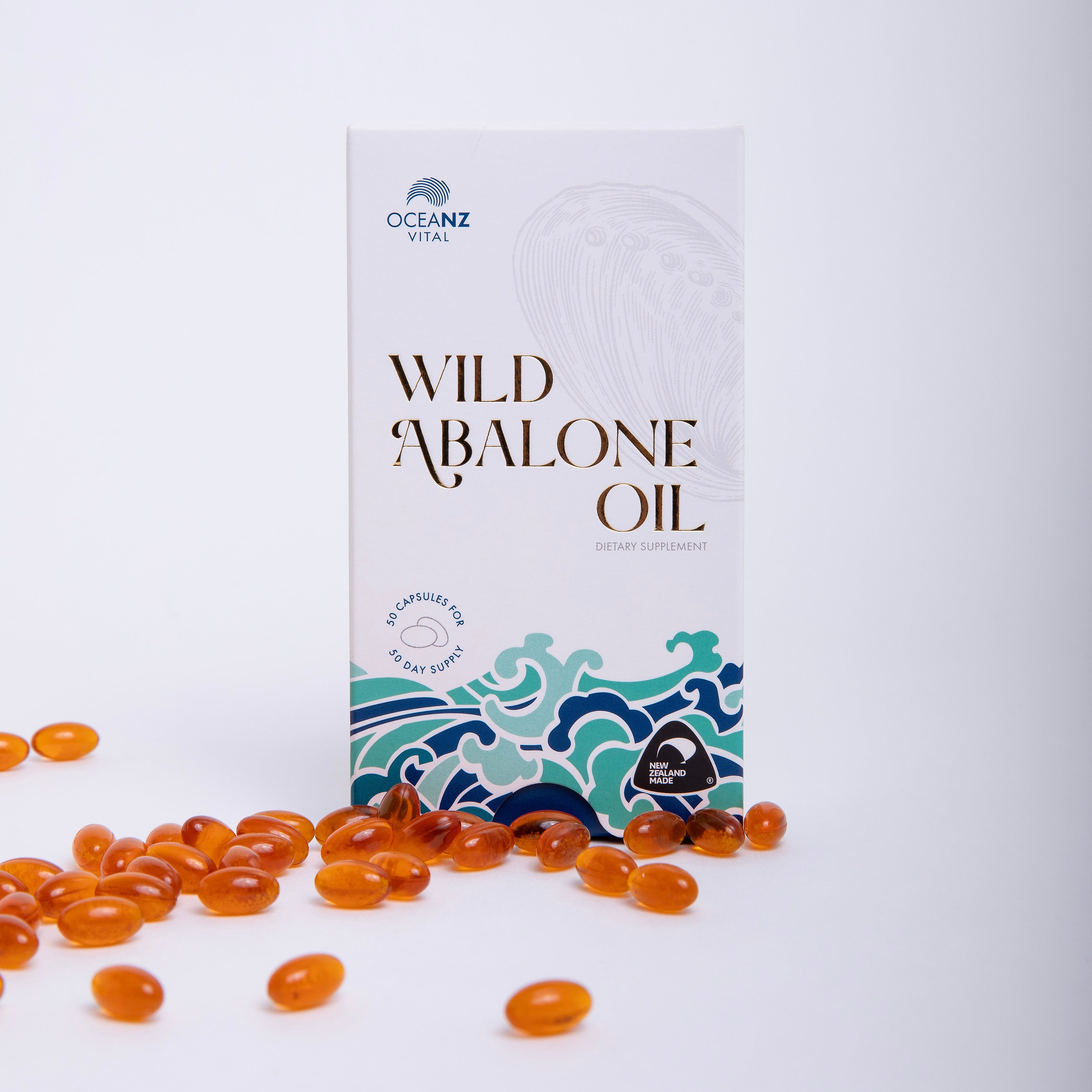 Box of Wild Abalone Oil with scattered capsules on a white background