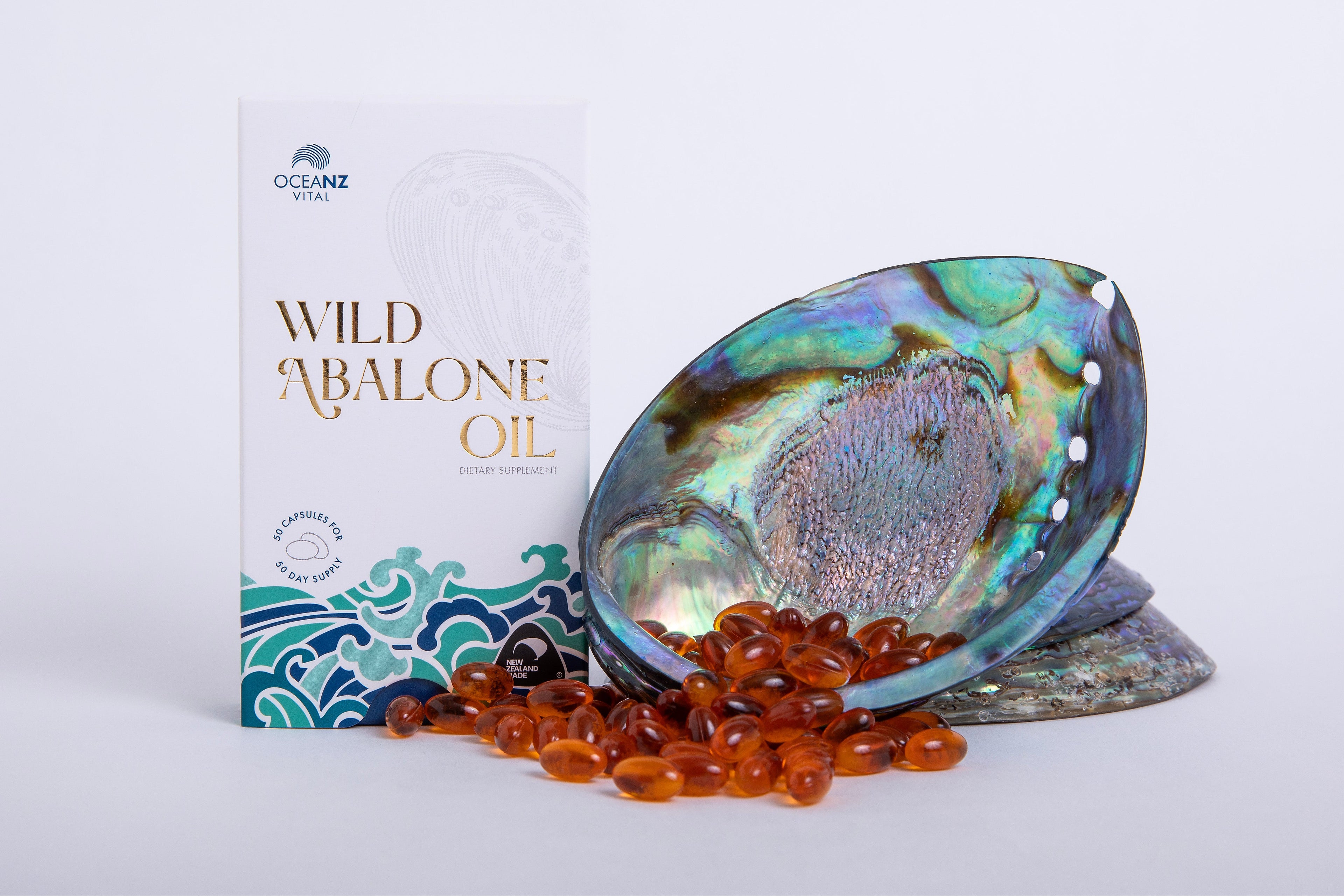 Wild abalone oil packaging with a shell and oil capsules on a white background